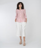 model in a wide leg white cropped pant with a red and white striped button down blouse