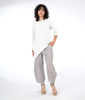 model in a striped pant with an asymmetrical white top