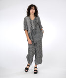 model in a wide leg black and white striped pant, with a matching top in black and white striped color blocking 