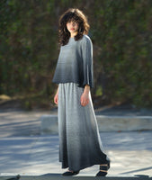 model in a wide leg pant in a white to black grid ombre print, and a matching pullover top with a full bell shaped body and wide sleeves