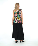 A woman modeling a sleeveless black top with a vibrant multicolor floral print, paired with wide-leg black pants and black slide sandals, against a solid white studio background.