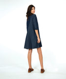 model in a dark wash chambray shirt dress