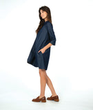 model in a dark wash chambray shirt dress