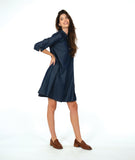 model in a dark wash chambray shirt dress