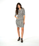model in a black and white stripe tunic with a hip pocket set into a diagonal seam across the body