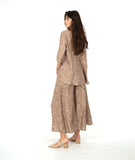 model in a wide leg pant with a pullover top with 3/4 sleeves and a flowy body. Top and pant are both taupe with a white leaf print