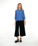 model in a white cropped pant with a blue button up blouse