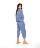 model in a two piece set consisting of a blue and white cargo pant and a button down blouse with 3/4 sleeves and a twin button detail