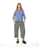 model in a blue and white striped button down with a matching pant in a black and white stripe. pant is barrel leg shaped with oversized pockets