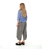 model in a blue and white striped button down with a matching pant in a black and white stripe. pant is barrel leg shaped with oversized pockets