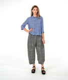 model in a blue and white striped button down with a matching pant in a black and white stripe. pant is barrel leg shaped with oversized pockets