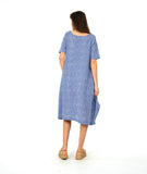 model in a blue and white striped dress with contrasting stripe direction panels, and shaping tucks at the hips