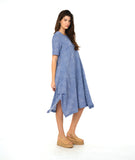 model in a blue and white striped dress with contrasting stripe direction panels, and shaping tucks at the hips