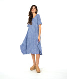 model in a blue and white striped dress with contrasting stripe direction panels, and shaping tucks at the hips