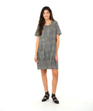 model in a short sleeve black and white striped knee length dress with a hip pocket set in to a diagonal seam across the body front