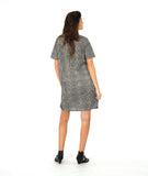 model in a short sleeve black and white striped knee length dress with a hip pocket set in to a diagonal seam across the body front