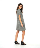 model in a short sleeve black and white striped knee length dress with a hip pocket set in to a diagonal seam across the body front