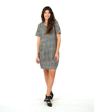 model in a short sleeve black and white striped knee length dress with a hip pocket set in to a diagonal seam across the body front