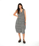 model in a black and white striped sleeveless dress with contrasting stripe directions and oversized pockets