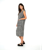 model in a black and white striped sleeveless dress with contrasting stripe directions and oversized pockets