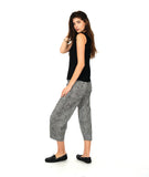 model in a black tank top with a black and white stripe wide leg pant with a tapered ankle