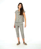 model in a slim crop pant in a soft grey and white stripe with a yellow textured dot print. worn with a matching cap sleeve blouse with yellow buttons