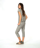 model in a slim crop pant in a soft grey and white stripe with a yellow textured dot print. worn with a matching cap sleeve blouse with yellow buttons