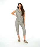 model in a slim crop pant in a soft grey and white stripe with a yellow textured dot print. worn with a matching cap sleeve blouse with yellow buttons
