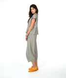 model in a wide barrel leg pant in a soft grey and white stripe with a yellow textured dot print. worn with a matching cap sleeve blouse with yellow buttons