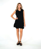 model in a black sleeveless dress with an oversized cowl neck. dress is black with small textured dots, and has side seam pockets, princess seams and shaping tucks at the hips