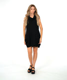 model in a black sleeveless dress with an oversized cowl neck. dress is black with small textured dots, and has side seam pockets, princess seams and shaping tucks at the hips
