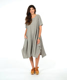A woman modeling a loose, short-sleeve midi dress with a gray and white vertical stripe pattern with a textured yellow dot. dress has an asymmetrical body, scoop neck and elbow length sleeves