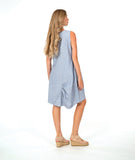 model in a sleeveless, knee length dress with an asymmetrical skirt. dress is a soft blue and white stripe with a small yellow textured dot print