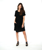 model in a black knee length dress with short sleeves and a round neckline. dress has a swirl texture and a diagonal seam across the body with a hidden seam pocket on the right