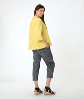 model in a yellow pullover top with 3/4 sleeves, a collar and a deep v. worn with a slim grey crop pant