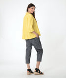 model in a yellow pullover top with 3/4 sleeves, a collar and a deep v. worn with a slim grey crop pant