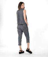 model in a grey sleeveless top with a twin button detail, worn with a matching slim crop pant