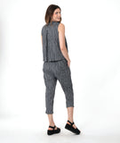 model in a grey sleeveless top with a twin button detail, worn with a matching slim crop pant