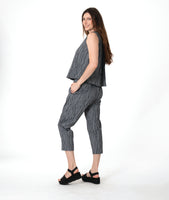 model in a grey sleeveless top with a twin button detail, worn with a matching slim crop pant