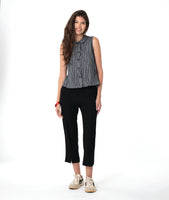 model in a grey sleeveless top with a twin button detail, worn with a slim black pant
