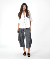 model in a grey barrel pant with a white button down blouse with a round collar and a cap sleeve