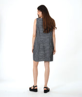 model in a grey sleeveless shift dress with a squared neckline and princess seams and gathered pockets at the hips