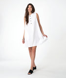 Woman wearing a white sleeveless shirt dress with  a black twin button detailing