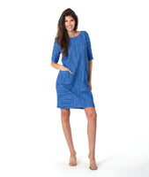model in a blue shift dress with princess seams and pockets at the hips