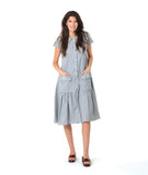 model in a grey and white pinstripe shirtdress with a gathered skirt detailng and hip pockets