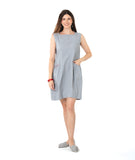 model in a sleeveless pinstripe shift dress with princess sleeves and a squared neckline. pockets are set into the seams and have a red embroidery detail