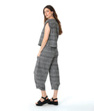 model in a boxy plaid black and white top with a matching wide leg pant with a tapered ankle and oversized exterior pockets