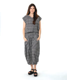 model in a boxy plaid black and white top with a matching wide leg pant with a tapered ankle and oversized exterior pockets