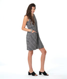 model in a sleeveless black and white plaid shift dress with princess seams, a squared neckline and hip pockets