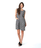 model in a sleeveless black and white plaid shift dress with princess seams, a squared neckline and hip pockets